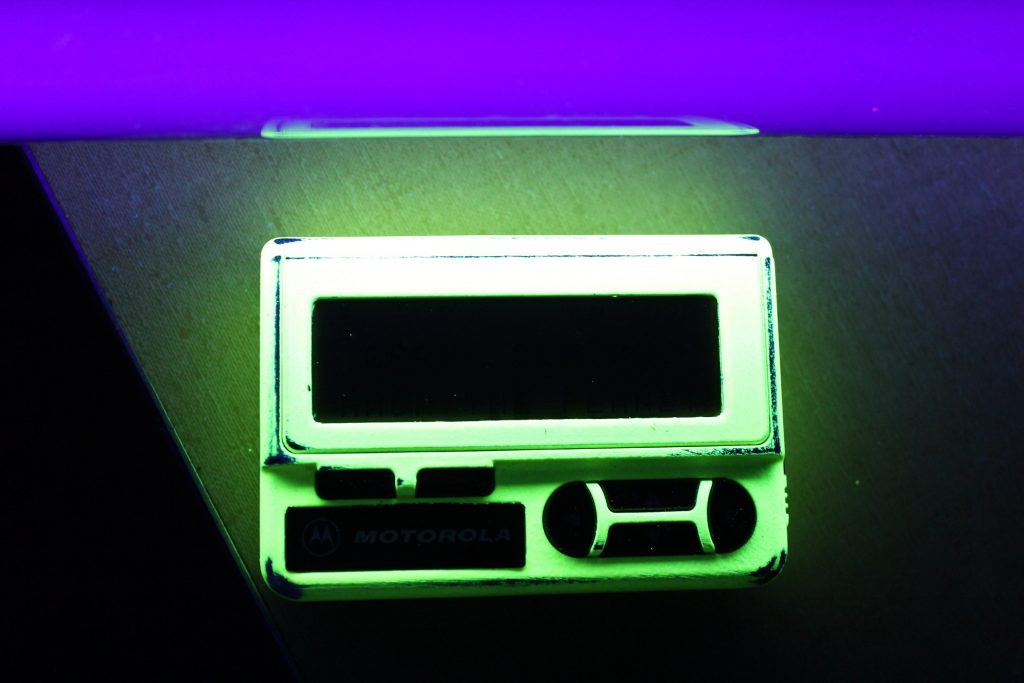 The pager body pops under UV light.